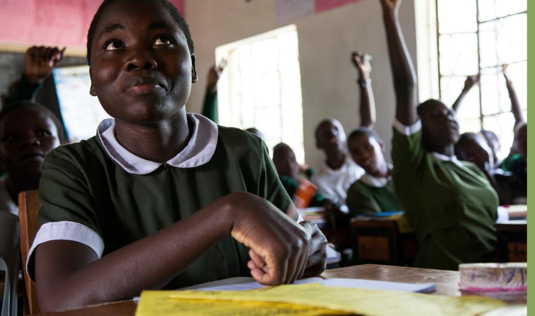 A young African girl participates in a school classroom