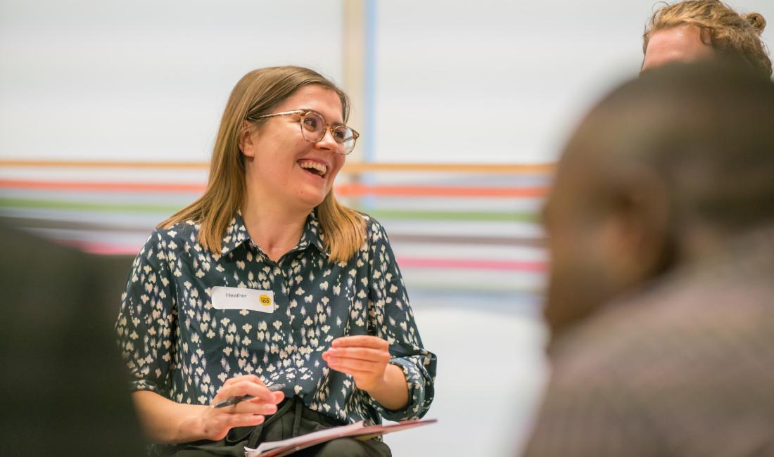Woman holding a clip board and laughing