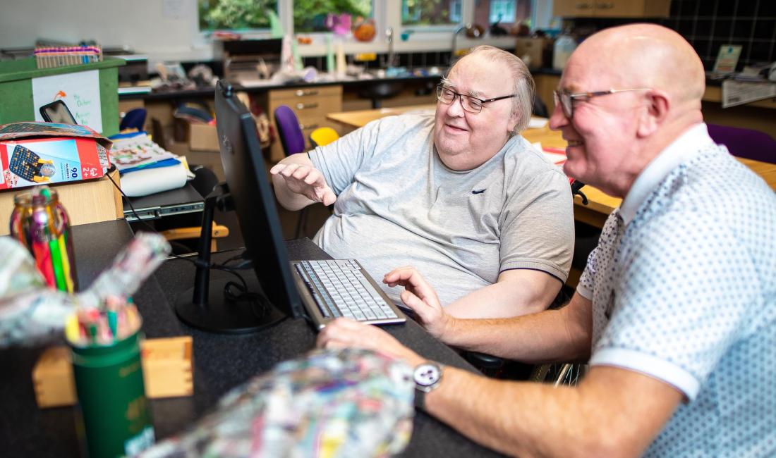Two men looking at a computer screen