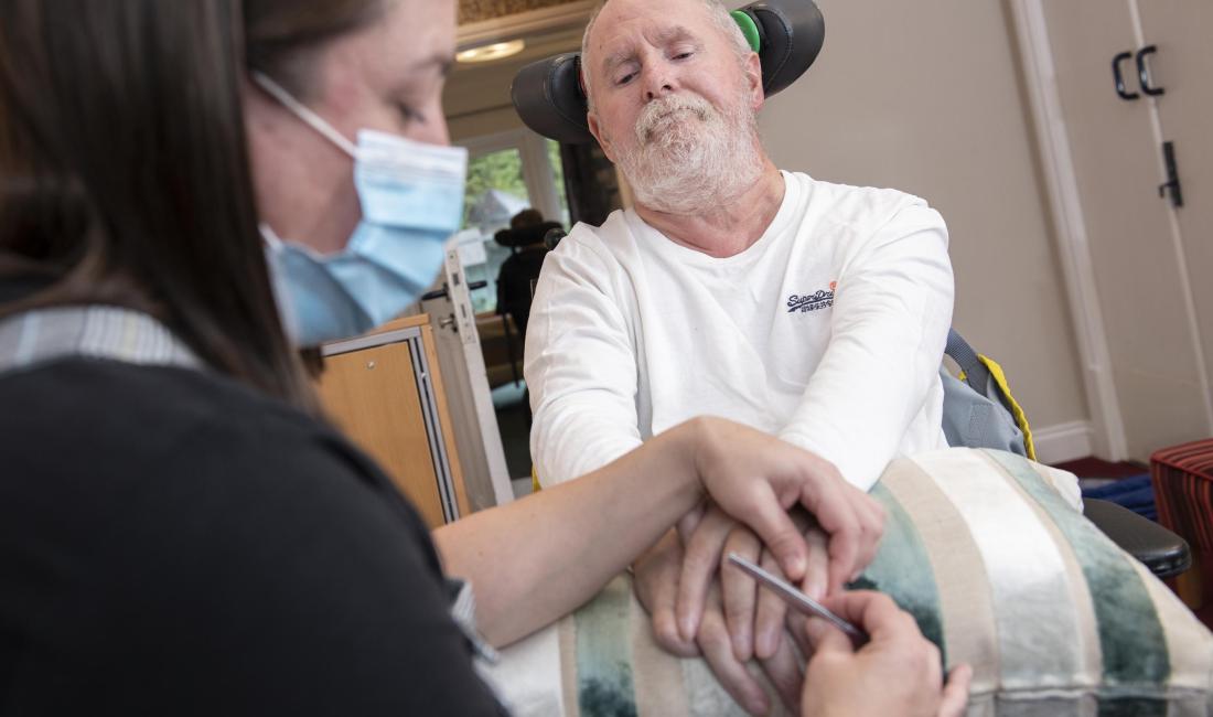 Cossham garden resident having nails filed